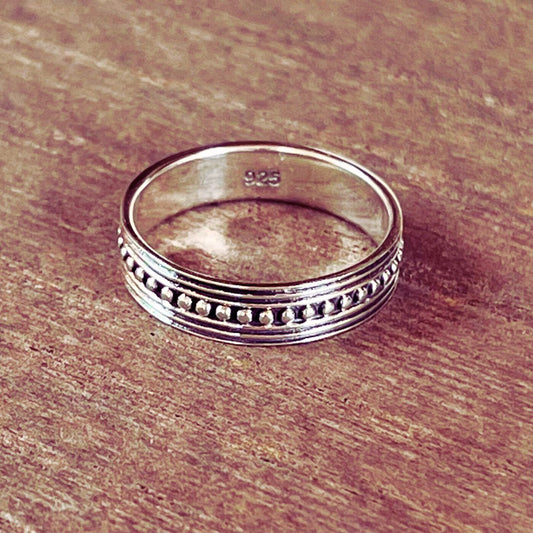 Bali style boho chic band ring made of genuine sterling silver on wood