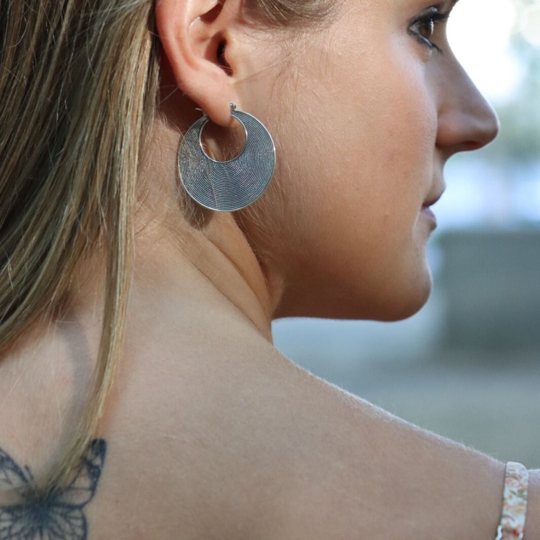 Side view of model wearing Balinese boho chic hoops made of sterling silver