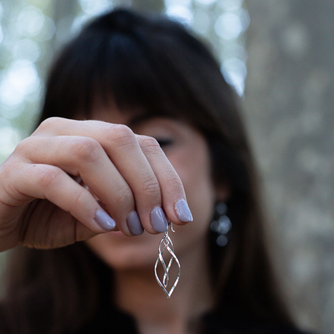 Boho chic Bai earrings made of genuine sterling silver held by model