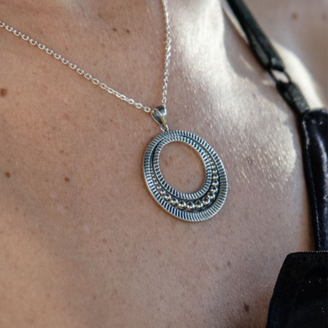 Closeup of Boho chic Bale pendant made of genuine sterling silver worn by model