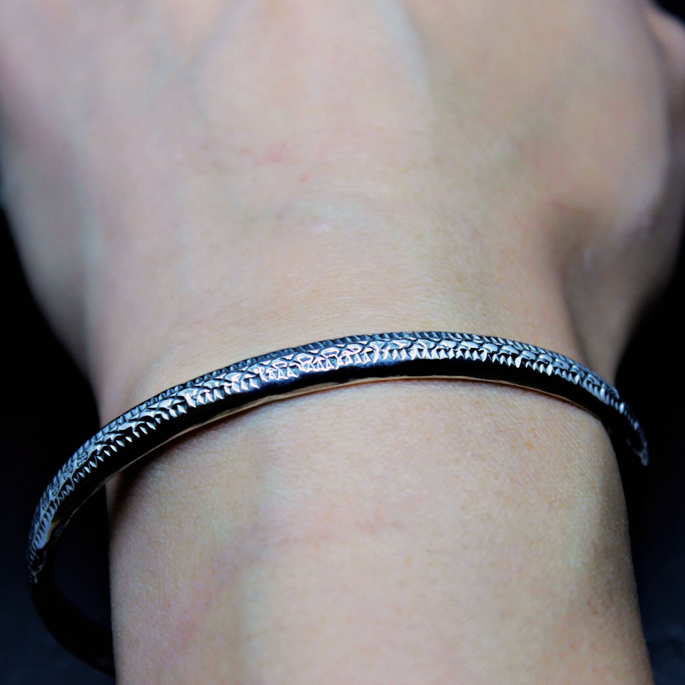 Handmade boho chic Batsu bangle made of sterling silver worn on left wrist