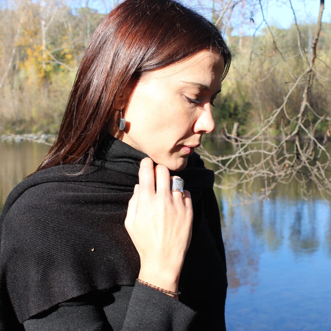 Model by the river wearing half circle boho chic Hangetsu earrings made from genuine sterling silver 