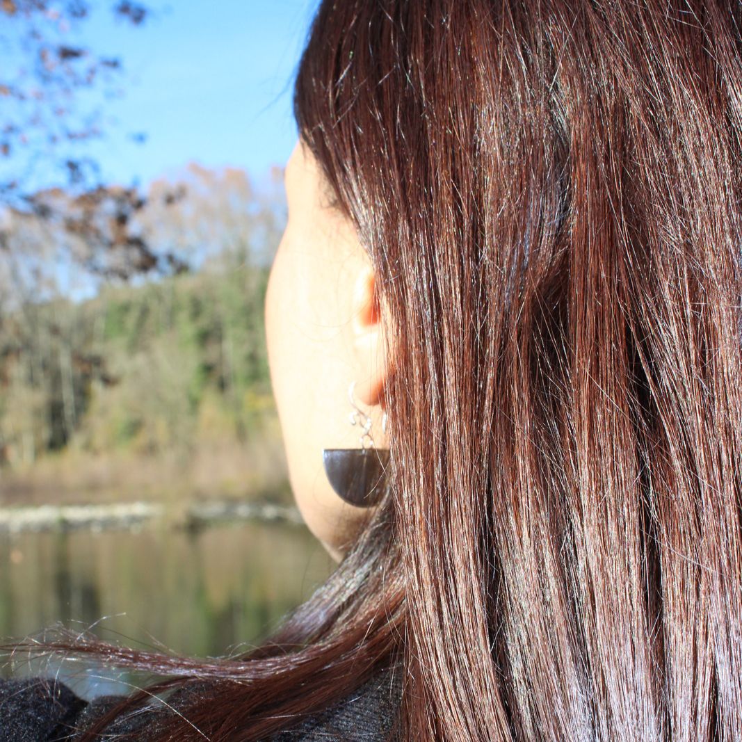 Closeup of model wearing half circle boho chic Hangetsu earrings made from genuine sterling silver 