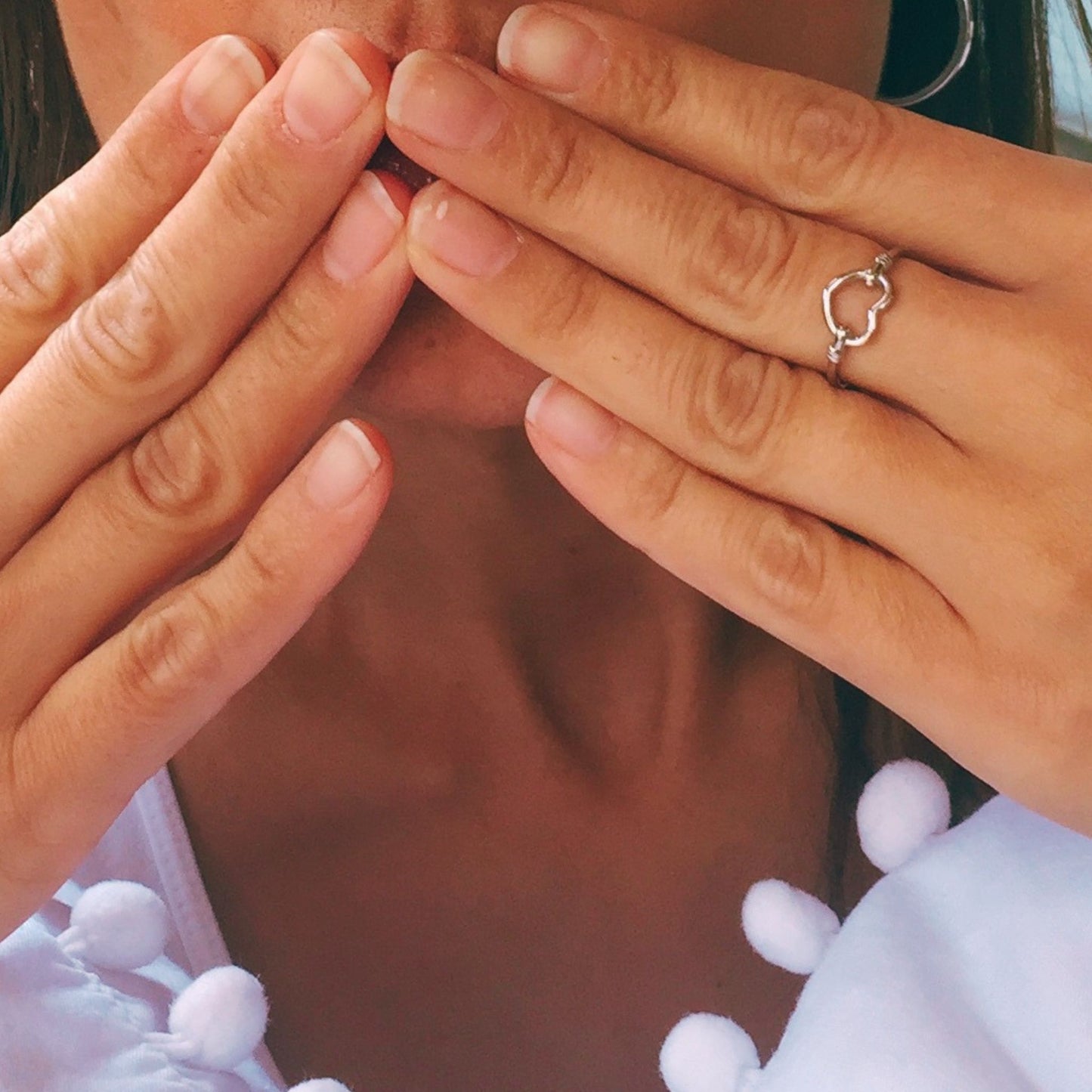 Model wearing delicate sterling silver boho chic stackable heart ring featuring a gorgeous heart design