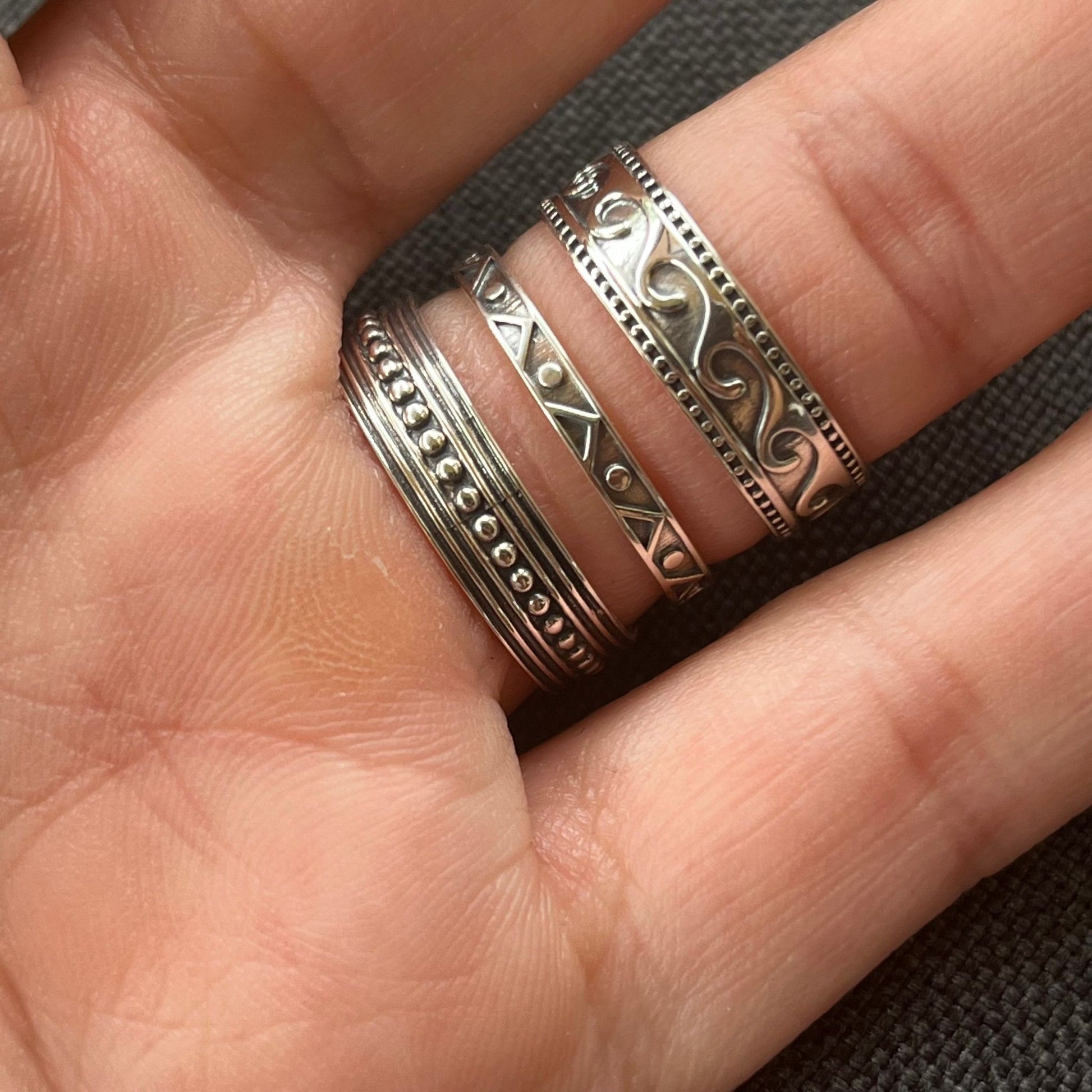 Closeup of a model wearing sterling silver bohemian boho chic Dotwaa band ring