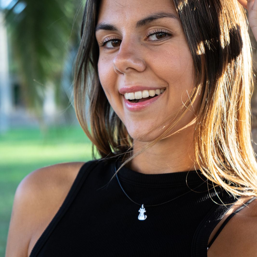 Model wearing sterling silver boho chic pendant featuring a cat